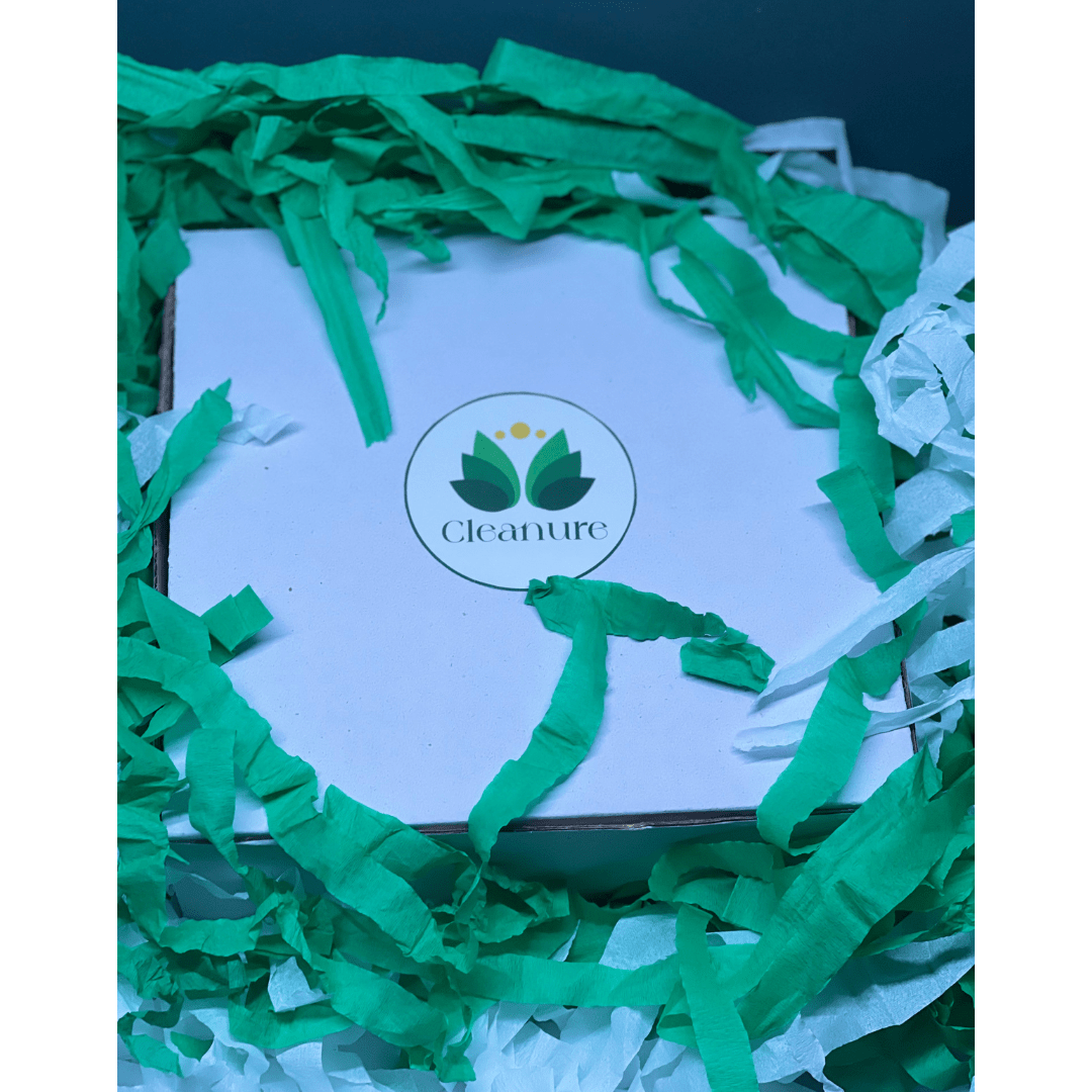 Product packaging with green crinkled paper and Cleanure logo on a blue background