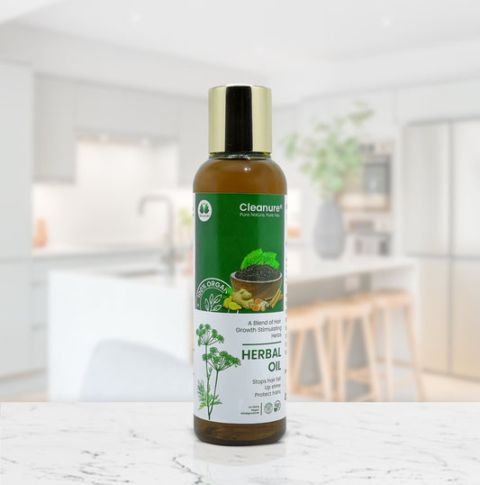 Bottle of Cleanure Herbal Oil on a white surface with a blurred indoor background