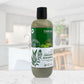 Bottle of Cleanure organic shampoo on a marble surface with a blurred indoor background