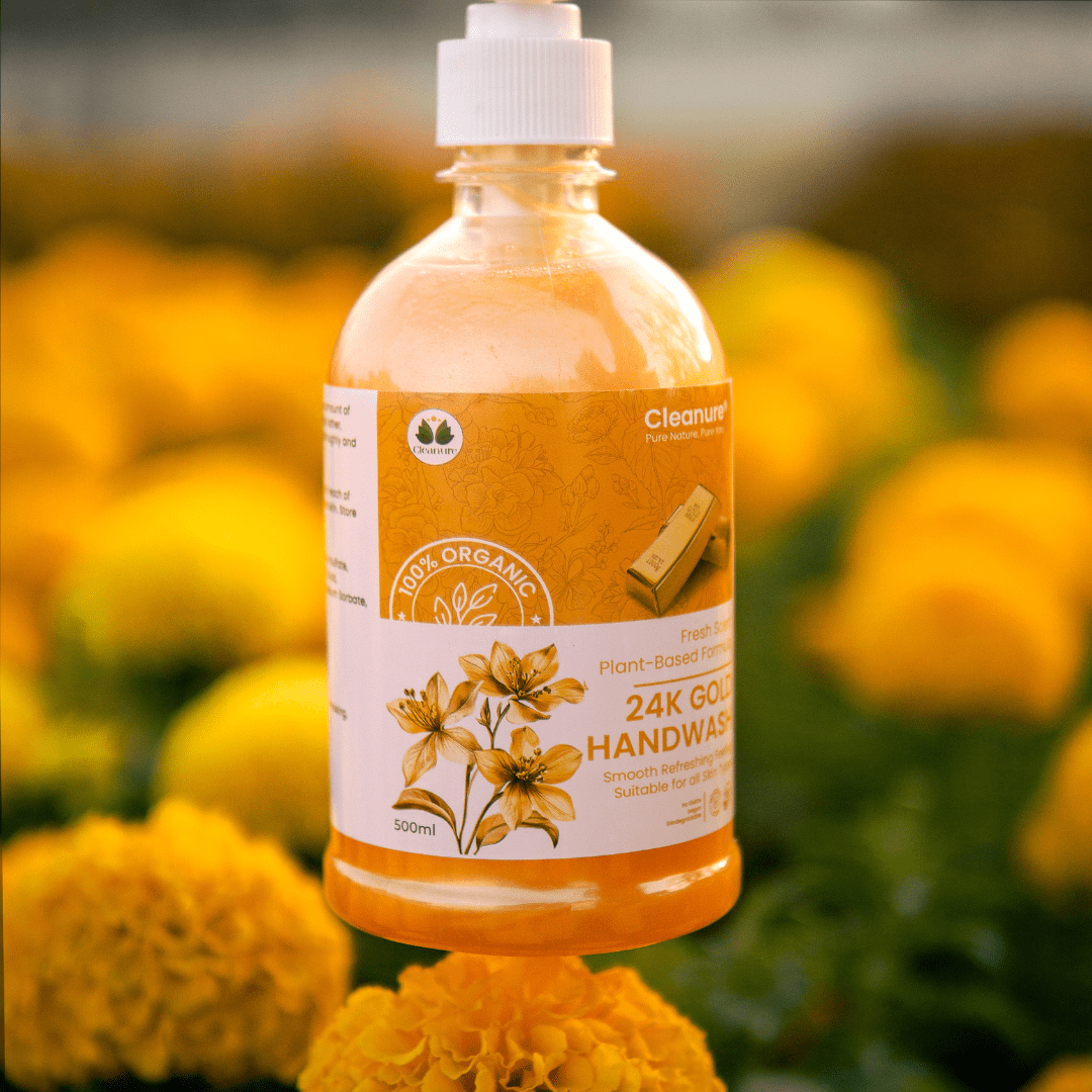Bottle of 24K Gold Handwash with a label on yellow flowers