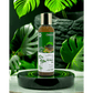 Herbal oil bottle with green leaves in the background