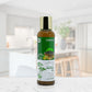 Bottle of Cleanure Herbal Oil on a white surface with a blurred indoor background